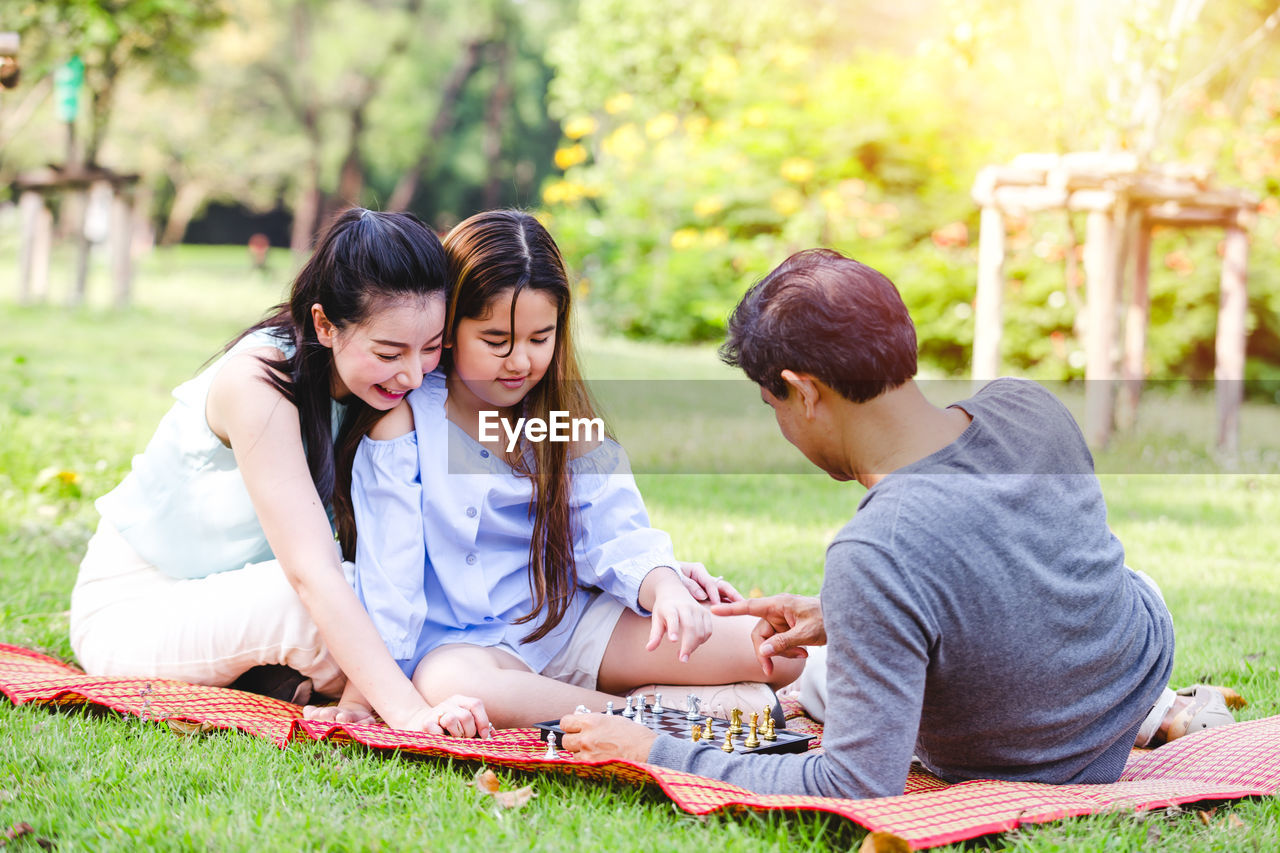 Cheerful family lying on field