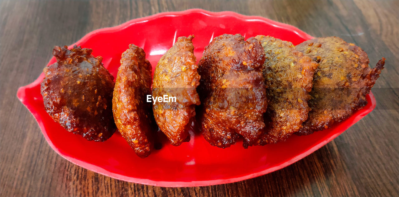 food and drink, food, fast food, dish, fried food, meat, freshness, wood, produce, no people, table, red, indoors, healthy eating, high angle view, close-up, vegetable, plate, fried, cuisine, wellbeing, still life, barbecue