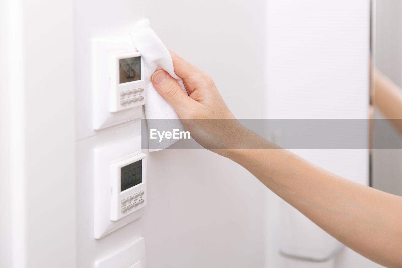 Cropped hands of woman holding button