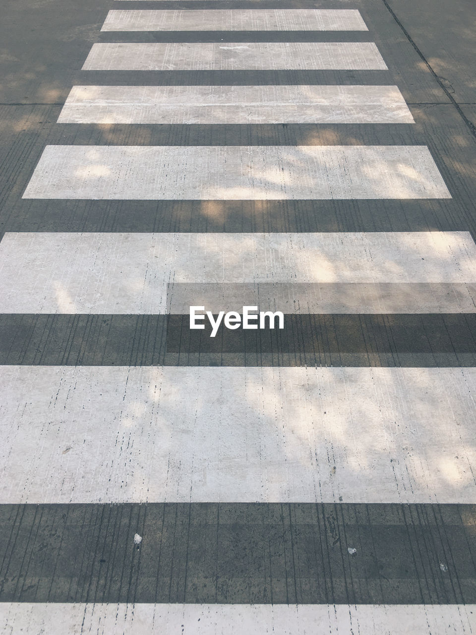 HIGH ANGLE VIEW OF ZEBRA CROSSING ON FOOTPATH