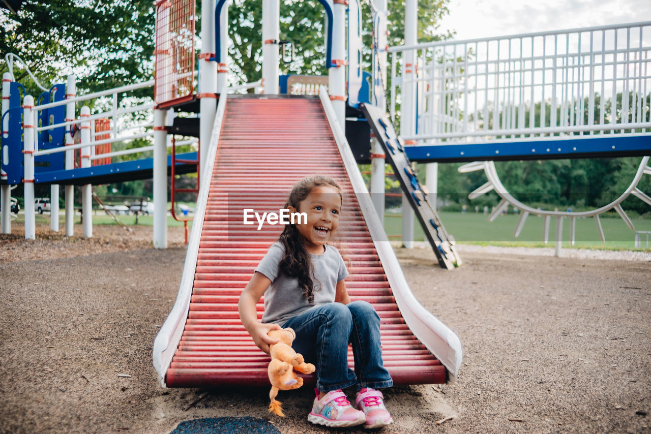 Mixed race family having fun at the kids park 