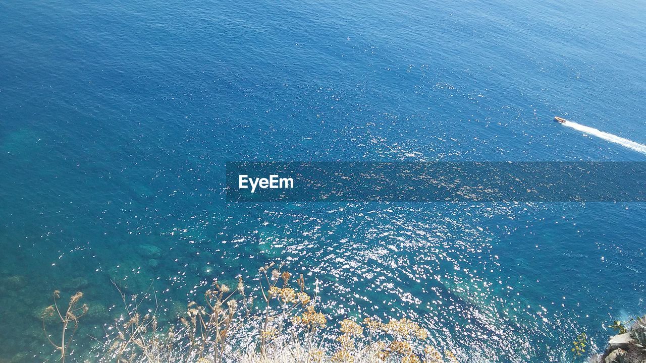 High angle view of sea against blue sky