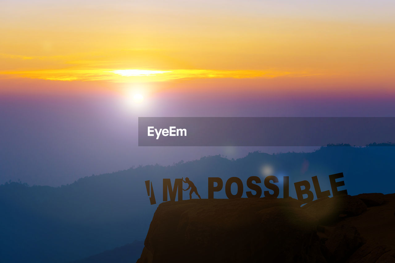 TEXT ON WALL AGAINST SKY DURING SUNSET