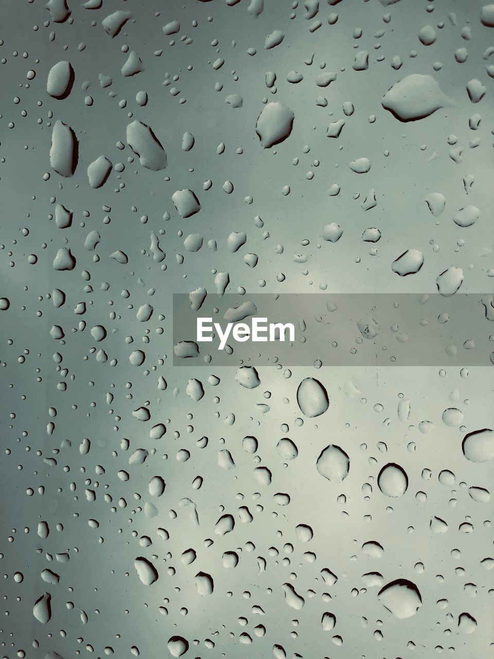 FULL FRAME SHOT OF WATER DROPS ON GLASS WINDOW