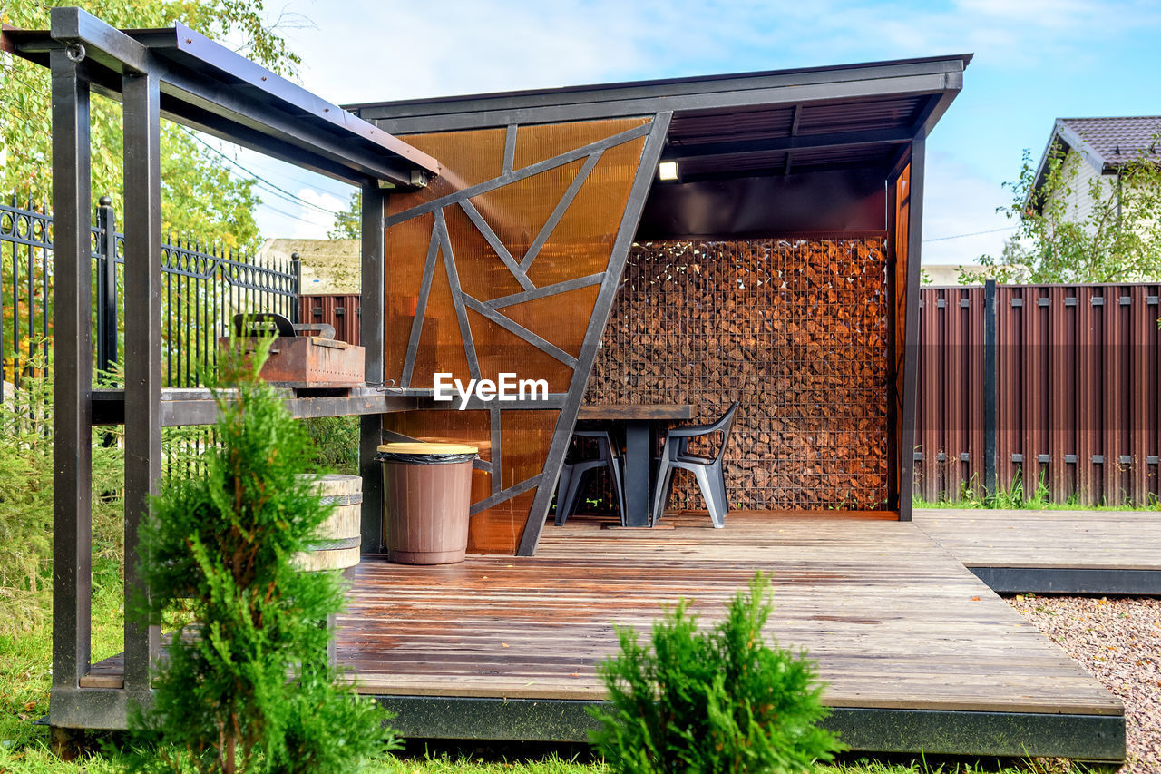 Picnic area with barbecue grill and table and chairs.