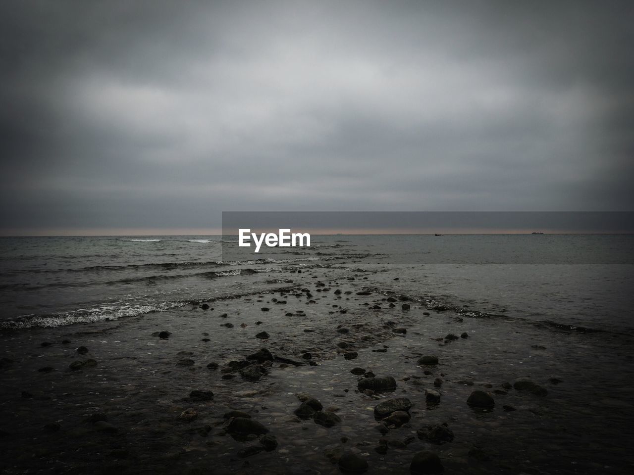 Scenic view of sea against cloudy sky