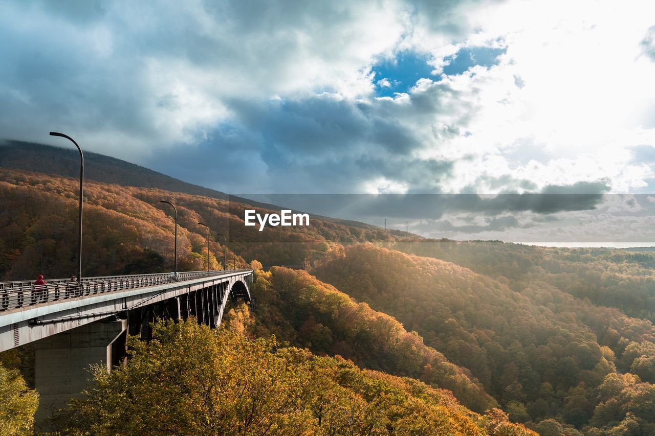 Scenic view of bridge and mountains against sky