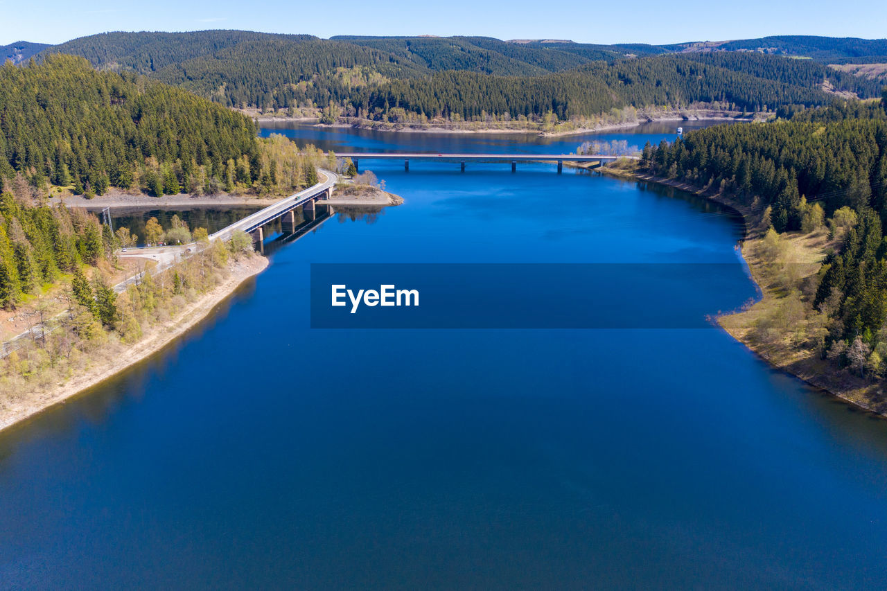 Aerial view of a flight over a reservoir in the harz mountains, a german low mountain range