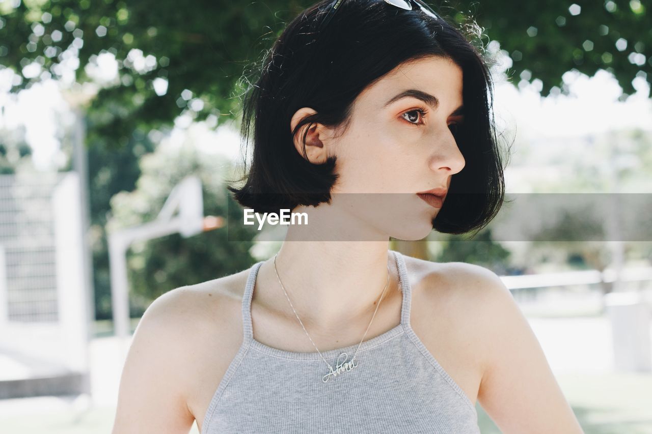 Close-up of beautiful young woman standing outdoors