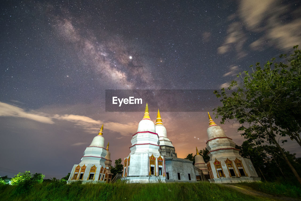 LOW ANGLE VIEW OF CLOCK TOWER AMIDST BUILDINGS AGAINST SKY