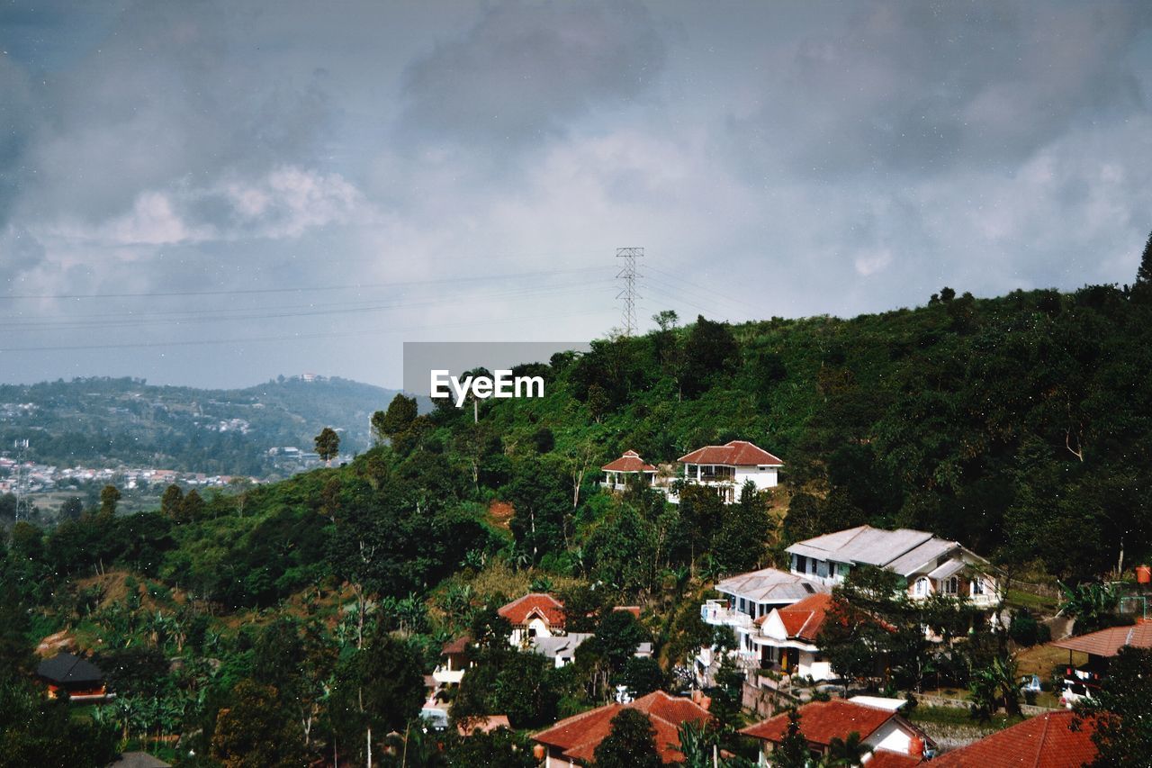 VIEW OF TOWN AGAINST CLOUDY SKY