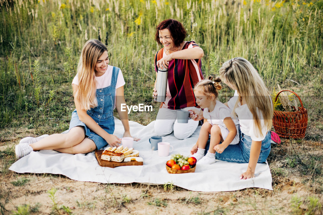 Two women sitting on ground