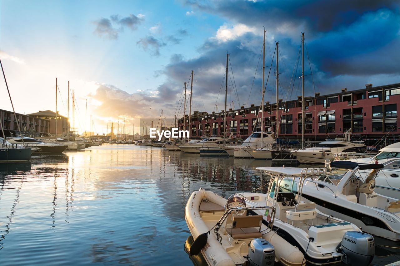 SAILBOATS MOORED IN HARBOR