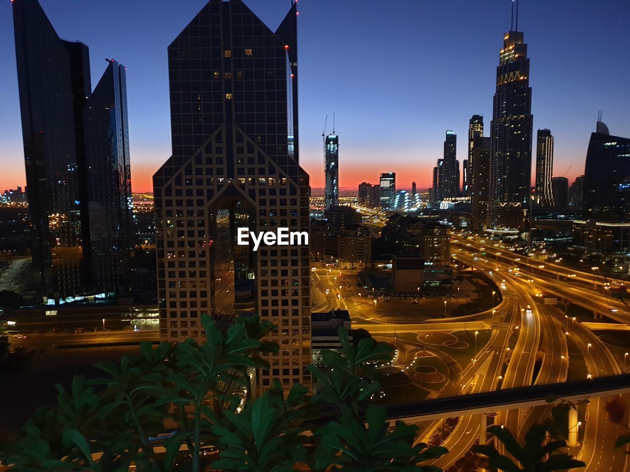 ILLUMINATED BUILDINGS AGAINST SKY AT DUSK