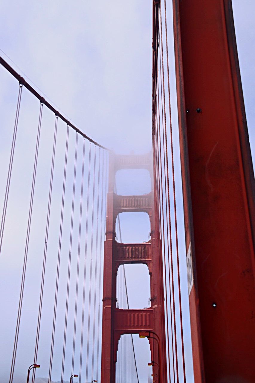 Low angle view of suspension bridge against sky