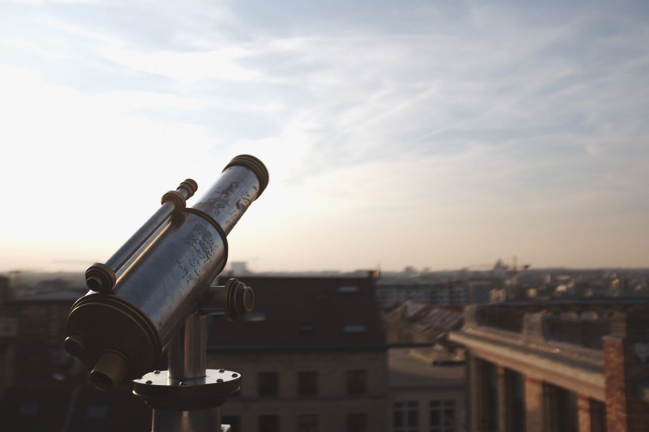 Coin-operated binocular against cityscape