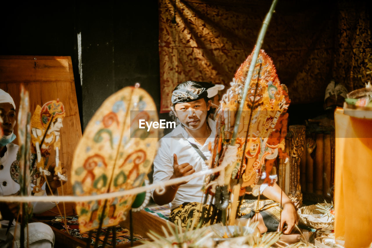 Portrait of young man in market stall