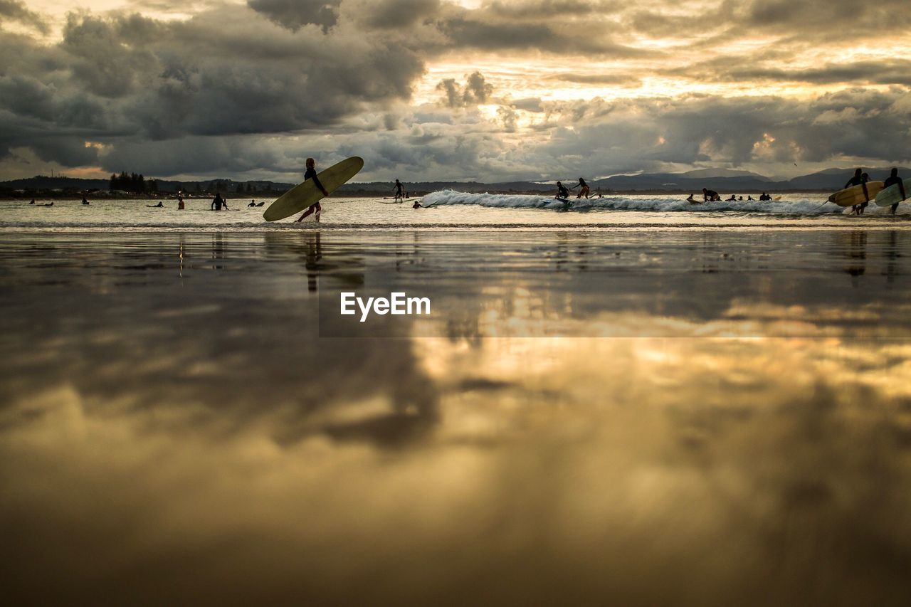 Clouds reflecting on beach during sunset