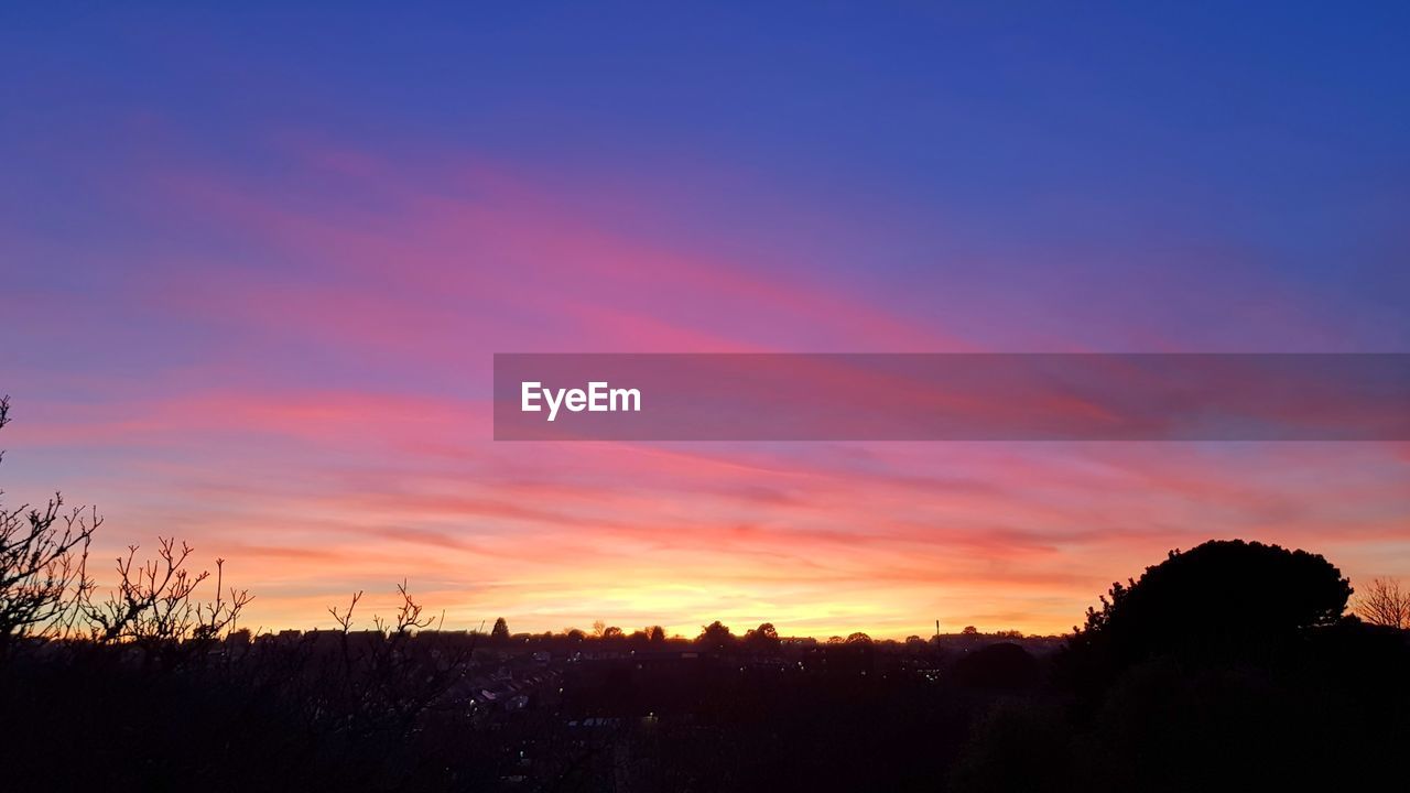 SCENIC VIEW OF SILHOUETTE LANDSCAPE AGAINST ROMANTIC SKY