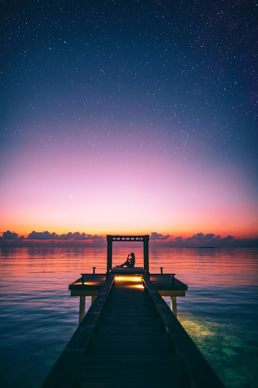 PIER AGAINST SKY AT NIGHT