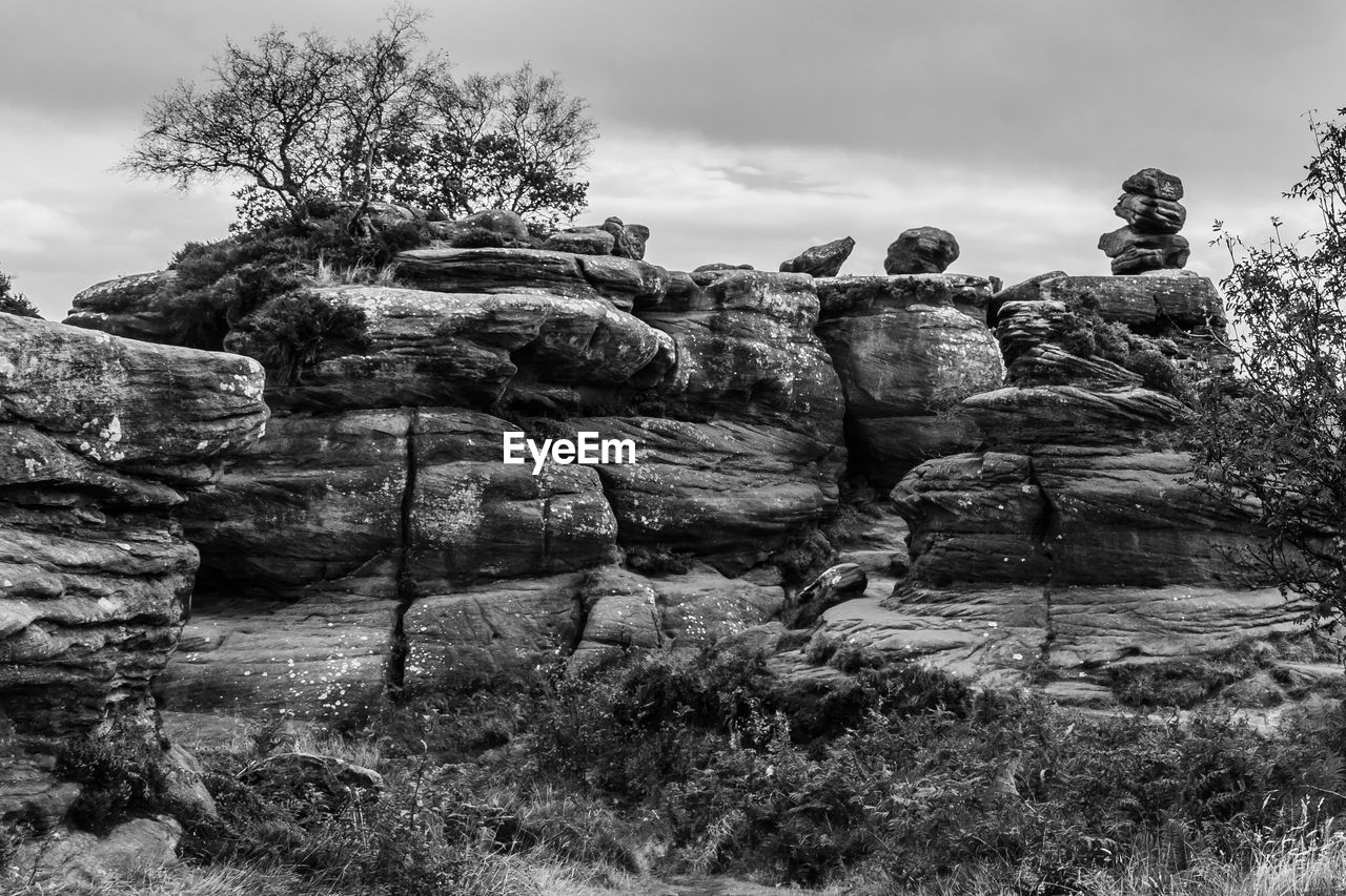 rock, sky, black and white, nature, ruins, plant, cloud, monochrome, tree, monochrome photography, land, no people, environment, landscape, outdoors, ancient history, day, history, scenics - nature, travel destinations, non-urban scene, tranquility, beauty in nature, travel, architecture, mountain, the past