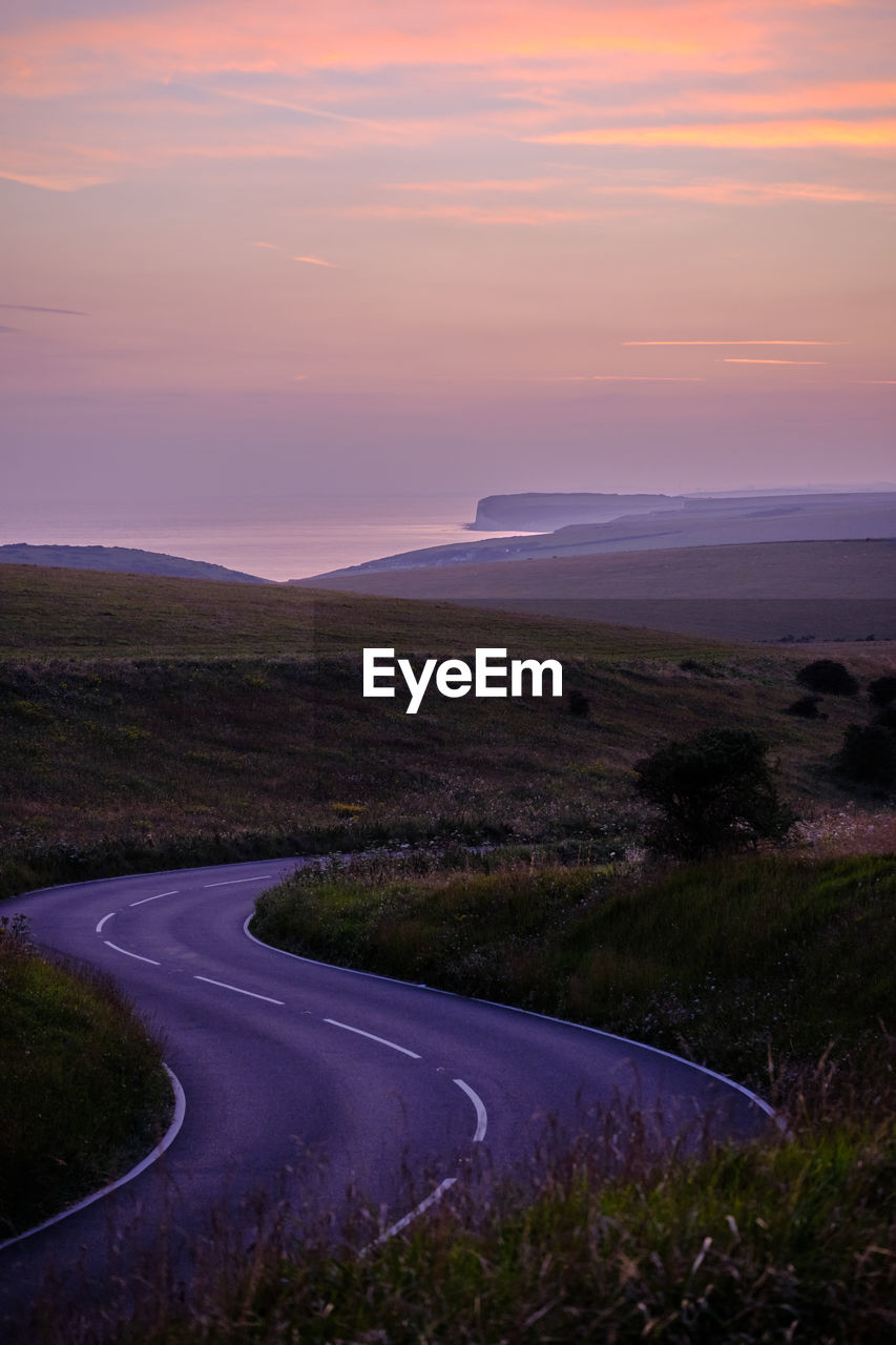 Beachy head z bends. a winding road in east sussex with cliffs and the sea in the distance