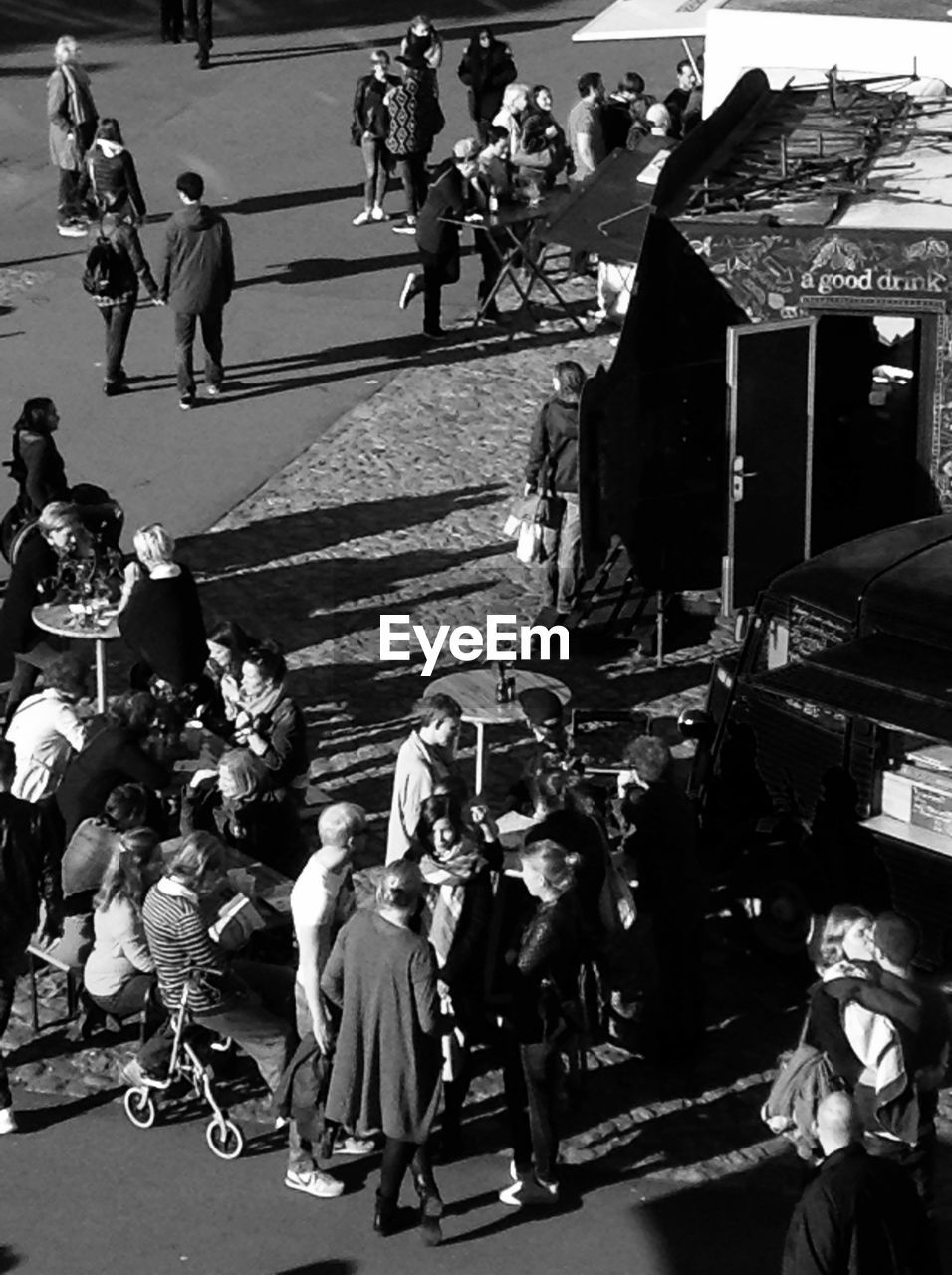 High angle view of people enjoying at sidewalk cafe