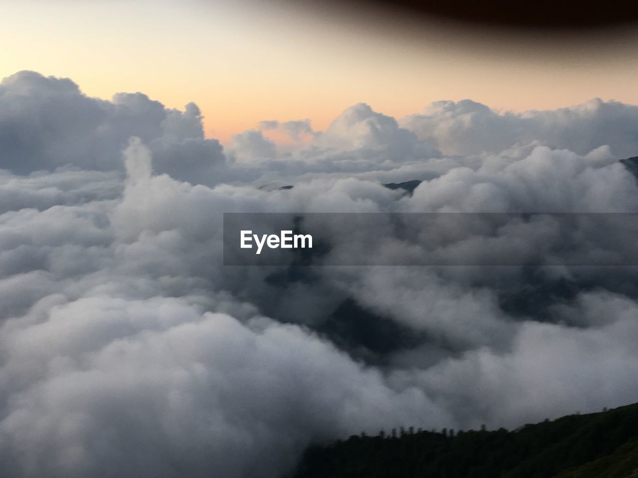 LOW ANGLE VIEW OF CLOUDS OVER MOUNTAIN AGAINST SKY