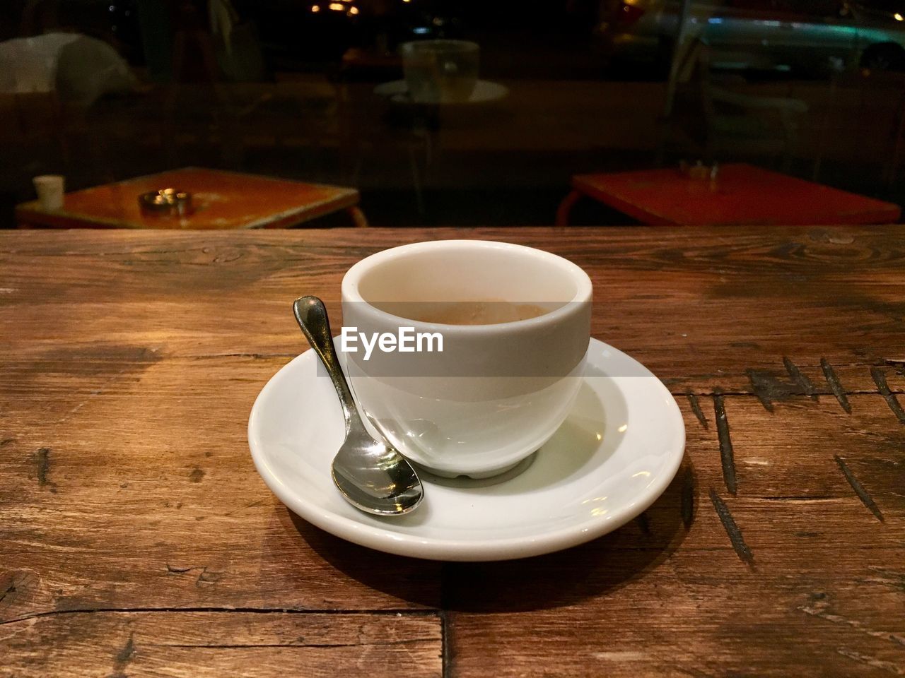 CLOSE-UP OF COFFEE CUP AND TABLE