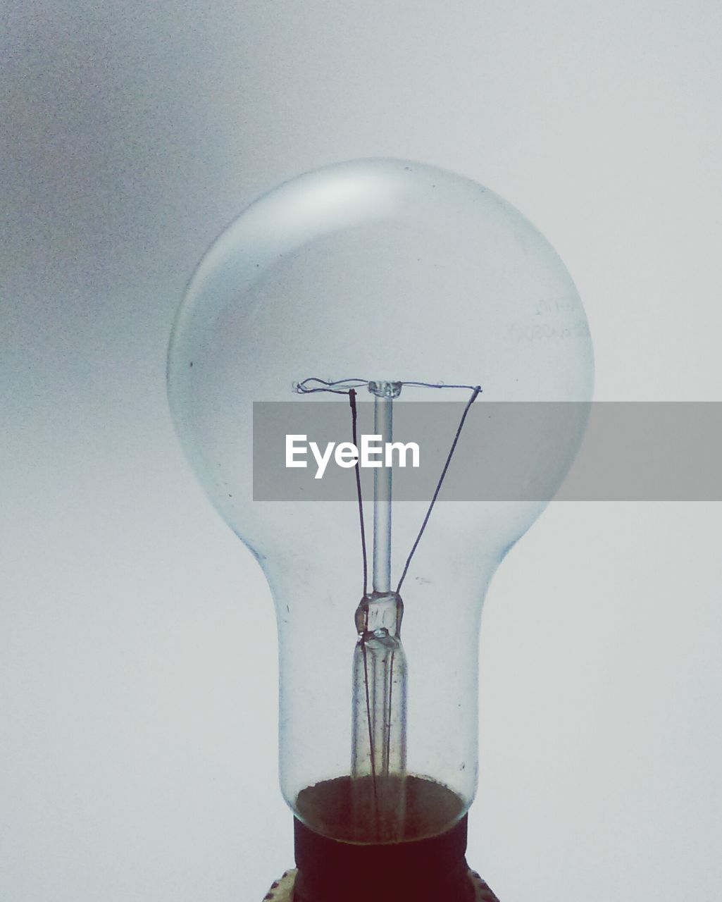 Close-up of light bulb against white background