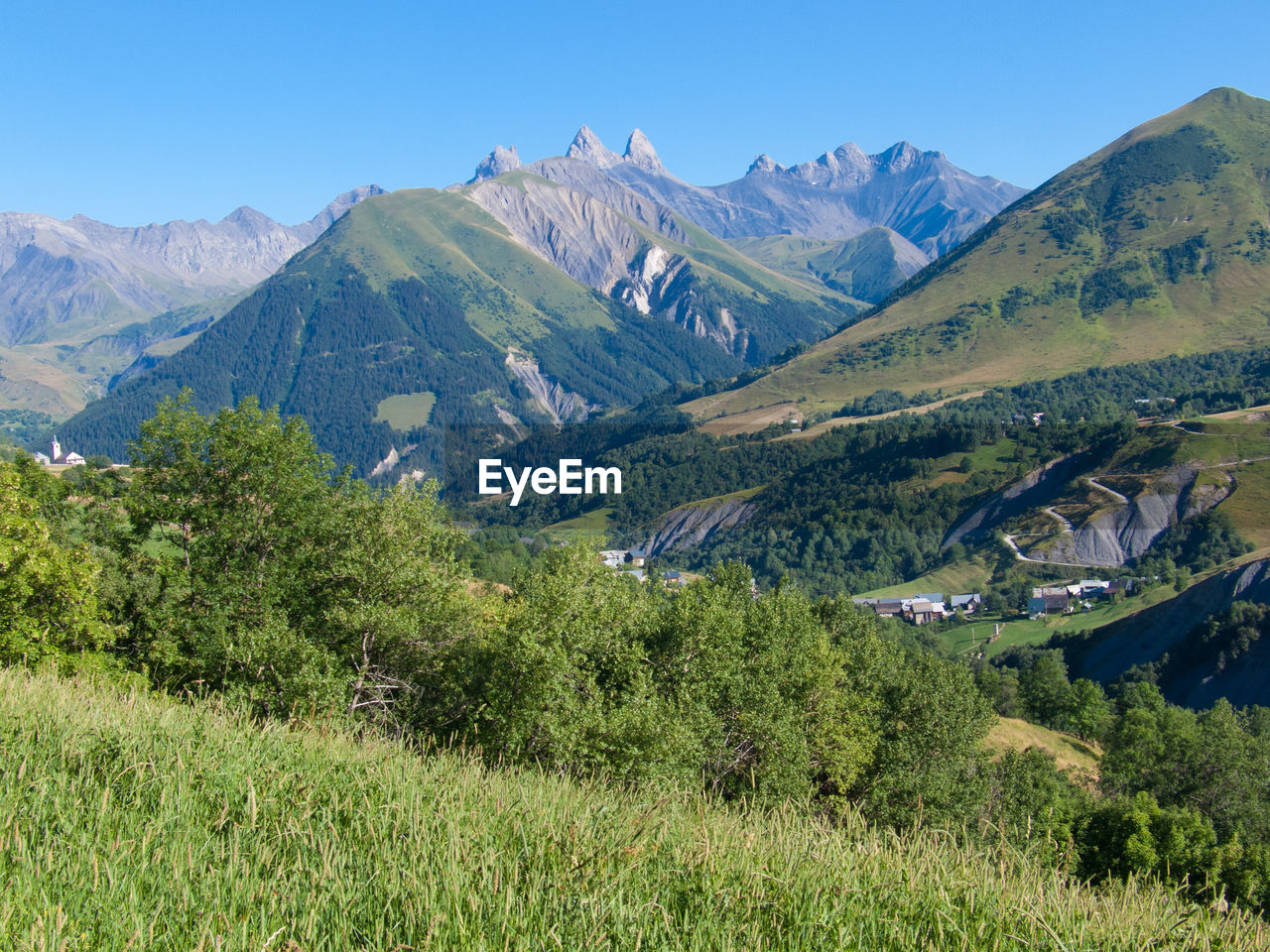 Scenic view of mountains against clear blue sky