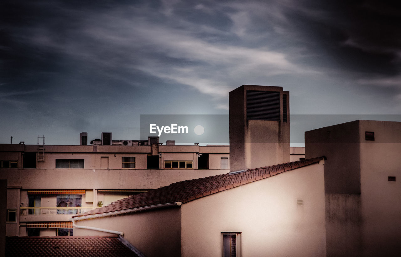 Low angle view of buildings against sky at night