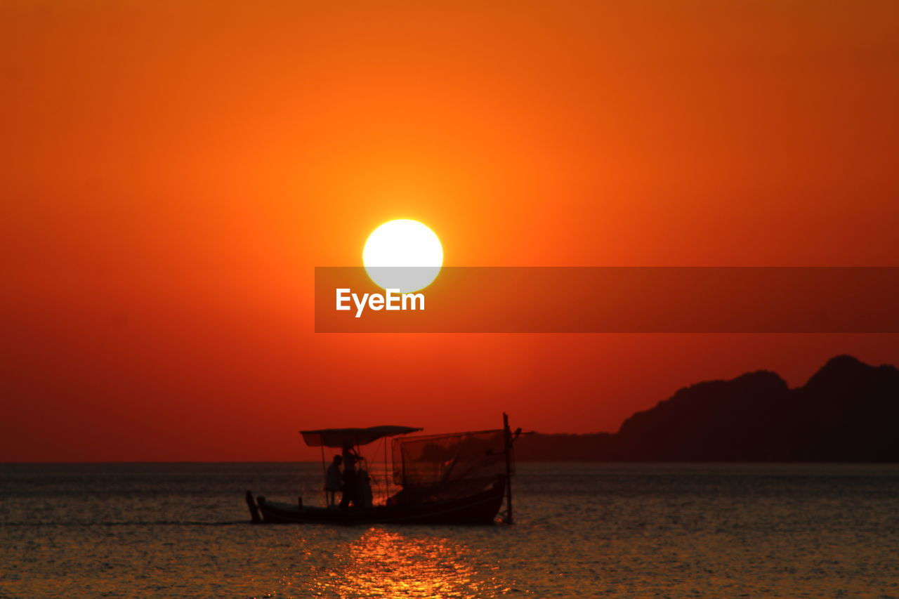 SCENIC VIEW OF SEA AGAINST ORANGE SKY DURING SUNSET