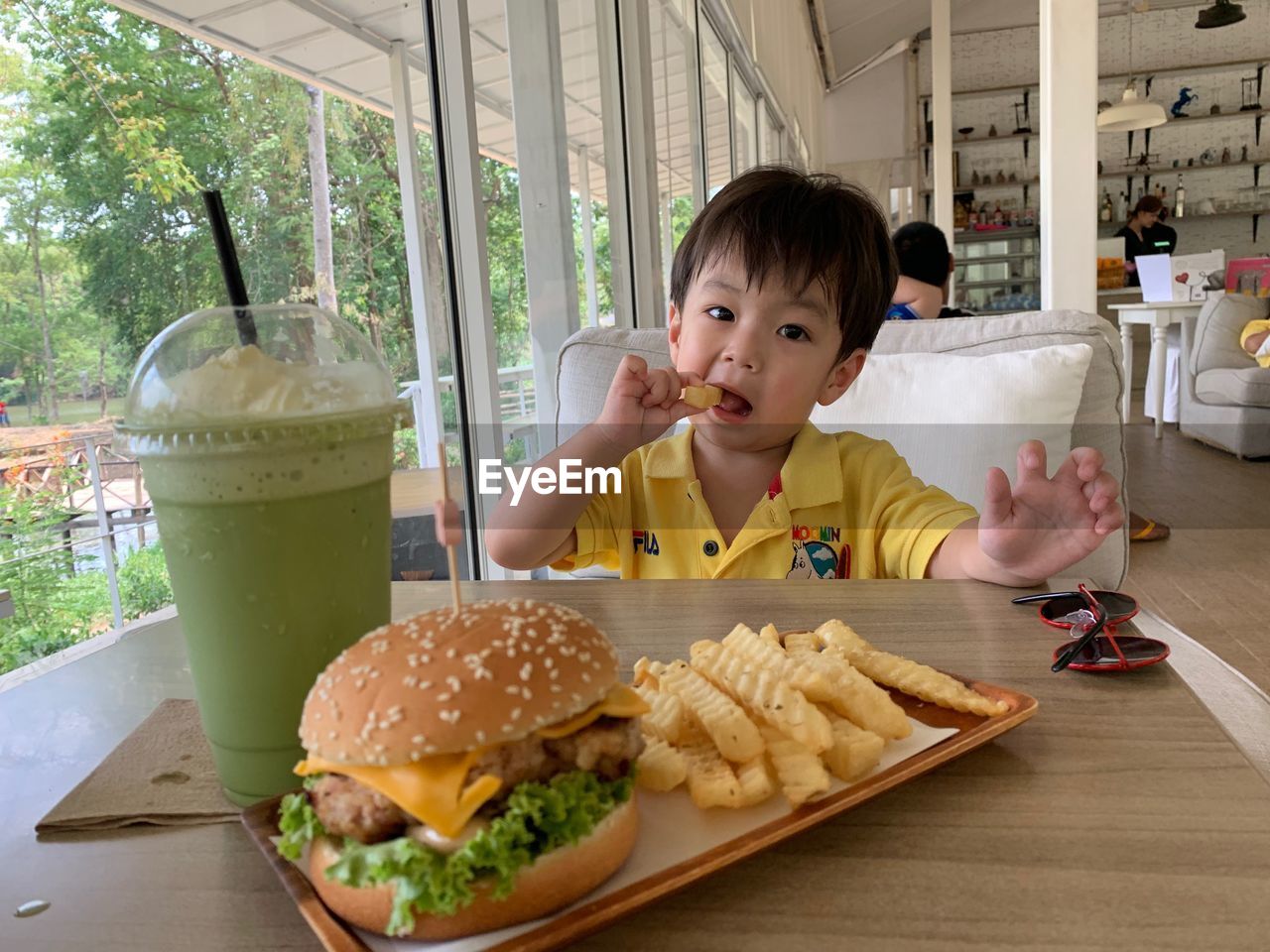 HIGH ANGLE VIEW OF BOY WITH VEGETABLES ON PLATE