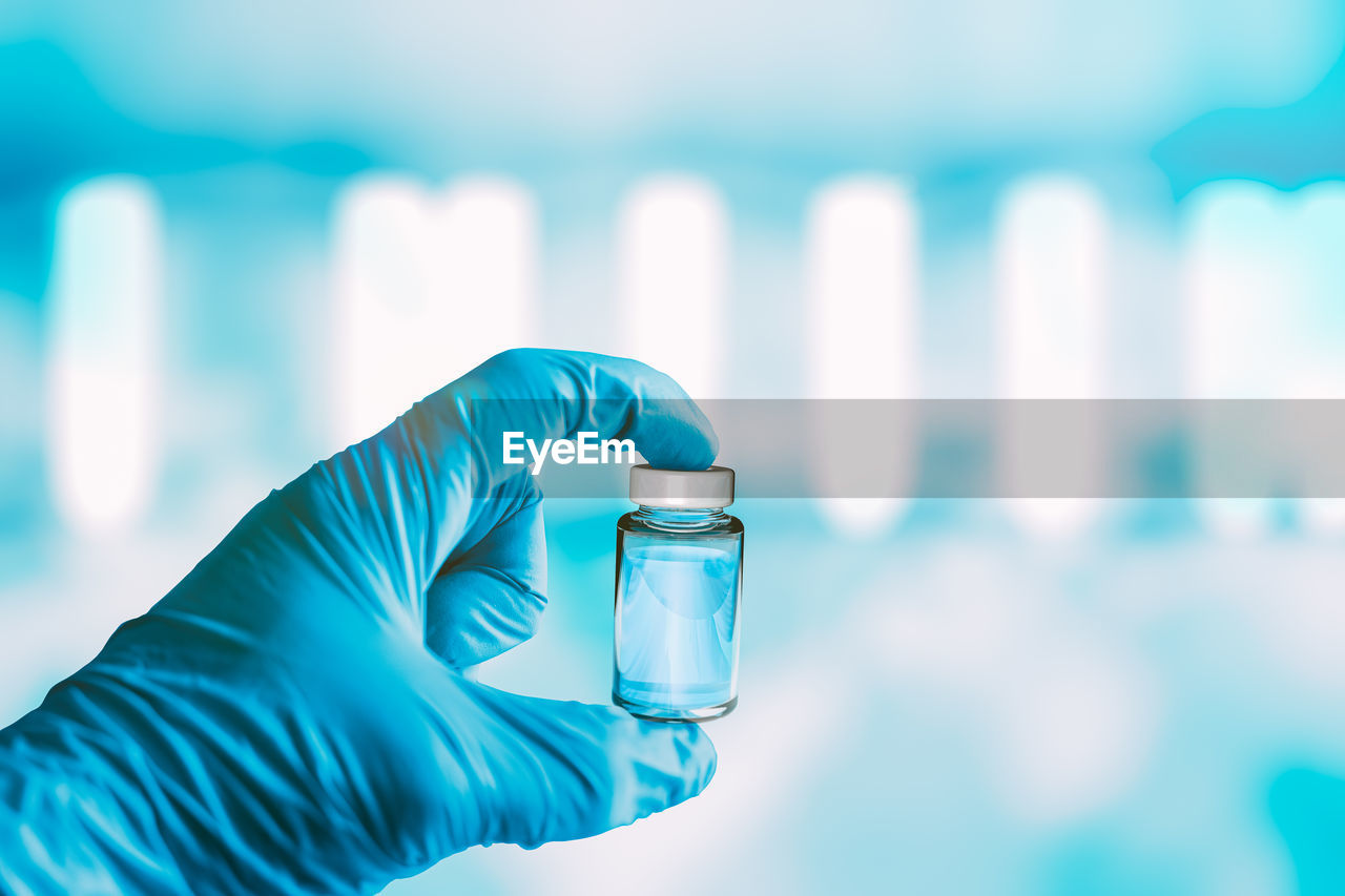 Hand holding vaccine in a lab