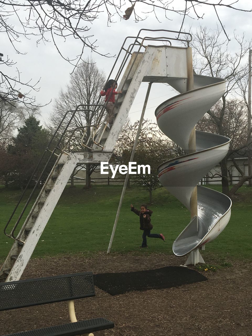 Children playing against sky in playground