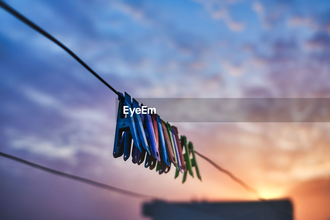 View of clothespins hanging on the wire