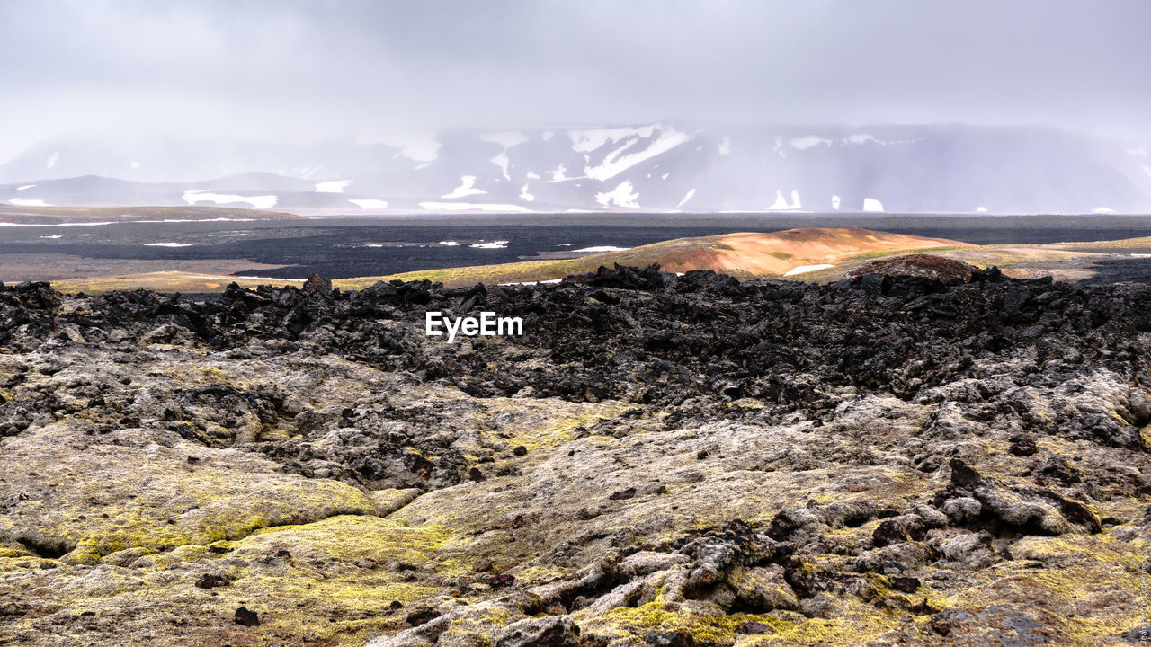 Scenic view of mountains and river against sky