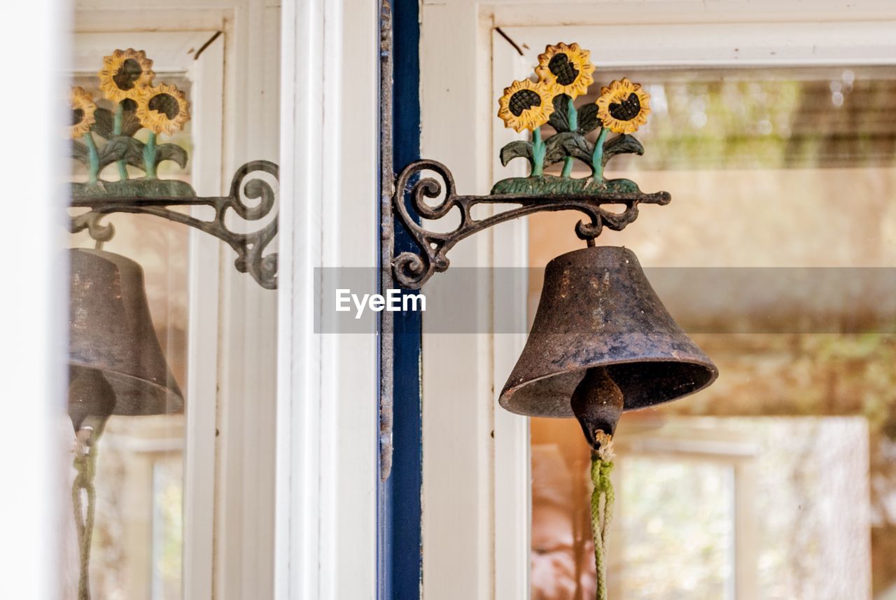 Close-up of bell hanging on wall