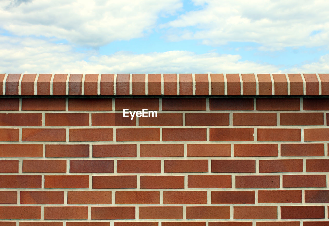 LOW ANGLE VIEW OF BRICK BUILDING AGAINST SKY