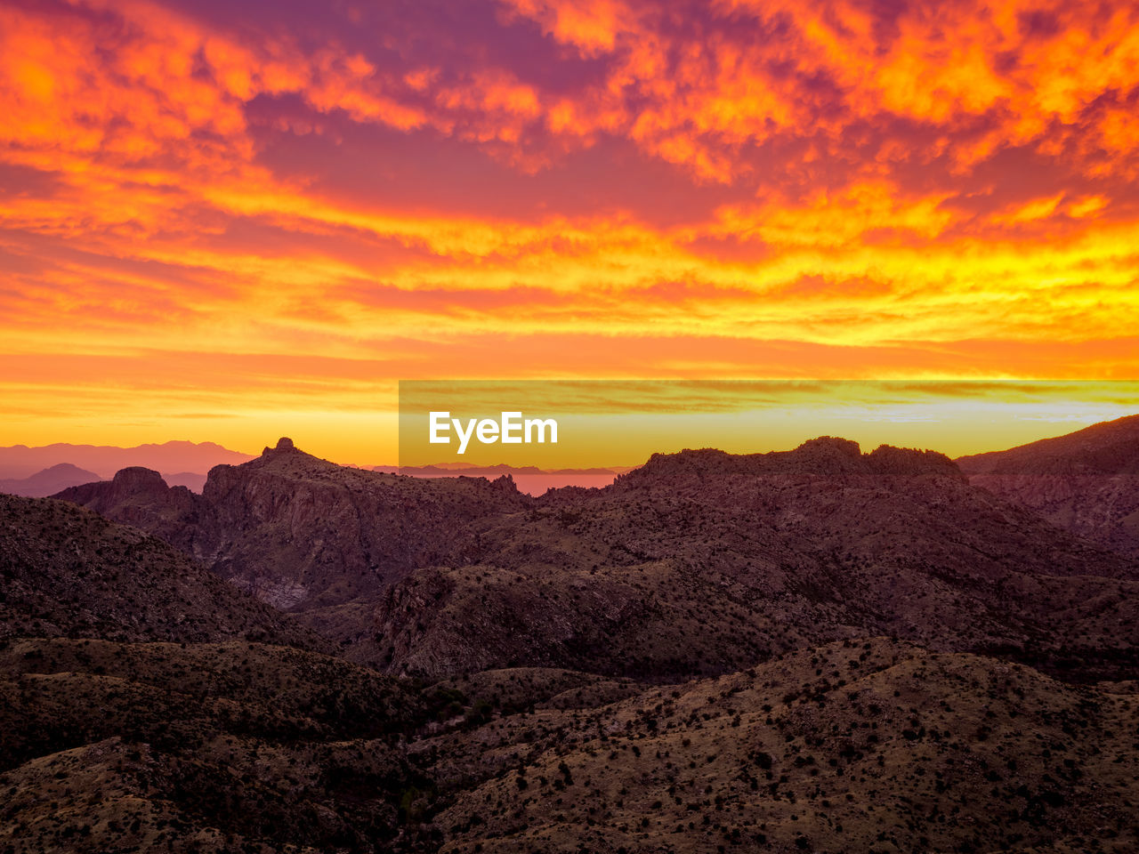 SCENIC VIEW OF MOUNTAINS AT SUNSET