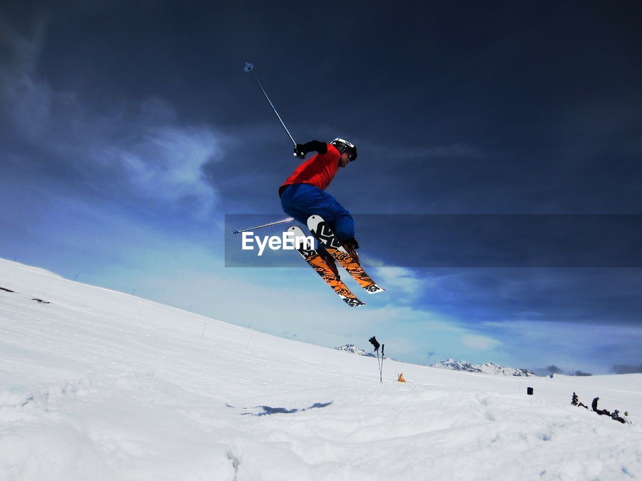 Low angle view of young man snowboarding in winter