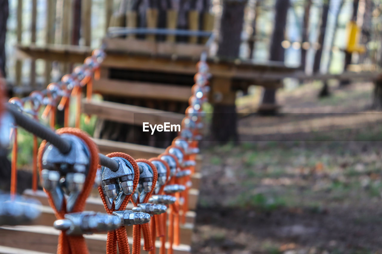 CLOSE-UP OF METALLIC RAILING AGAINST BUILDINGS