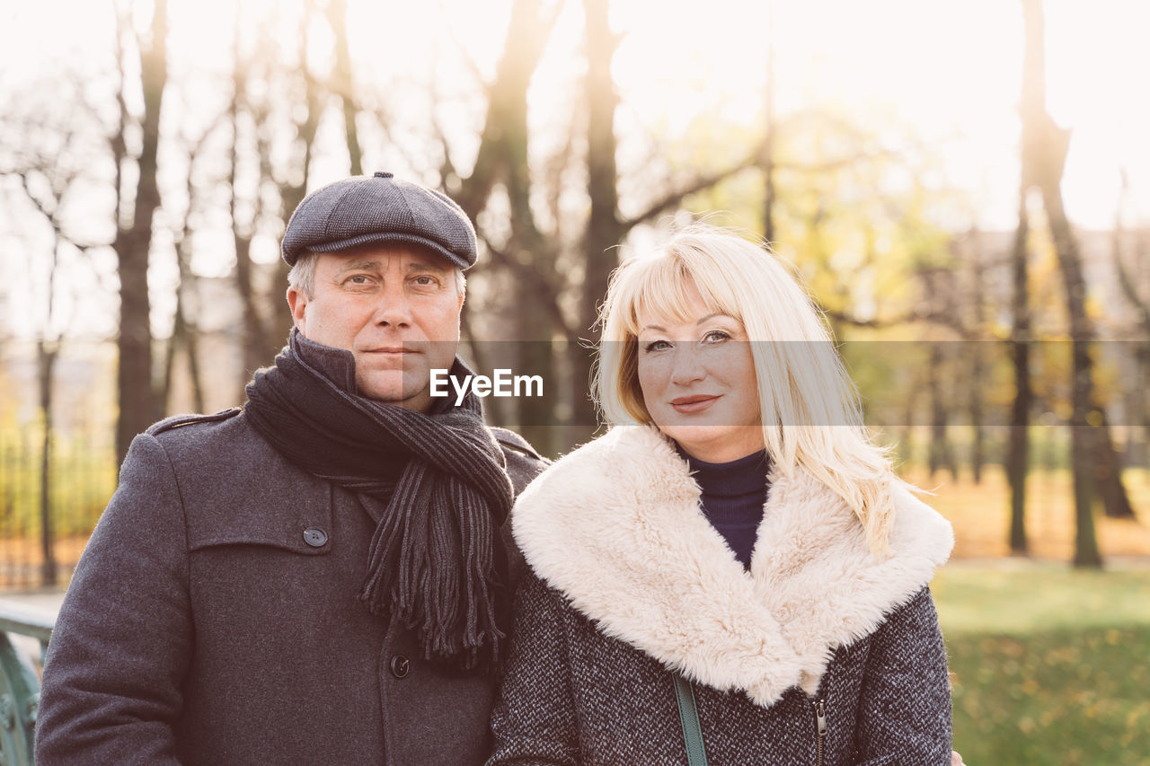 Portrait of couple standing in park during winter
