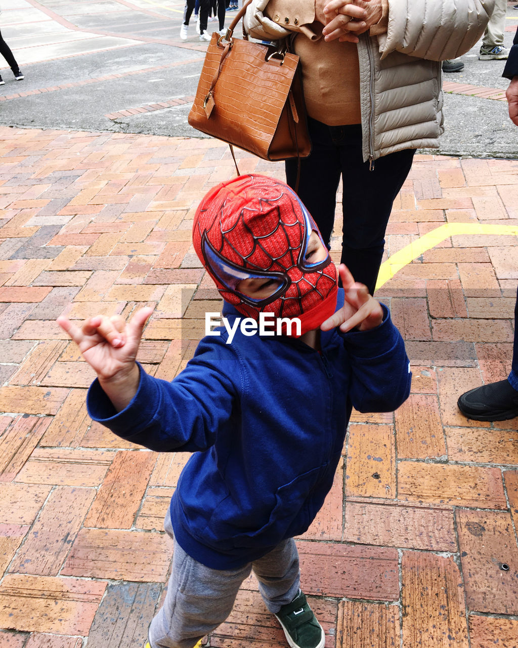 HIGH ANGLE VIEW OF BOY ON STREET