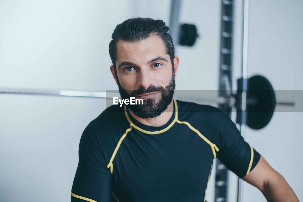 Portrait of beautiful sweaty man after training gym session. young sporty boy after work out 