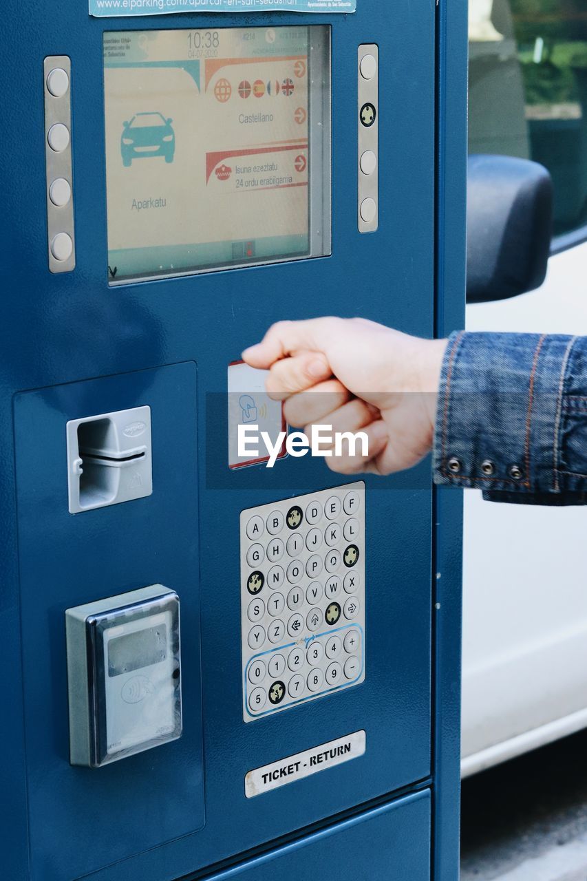 Low angle view of man paying the parking