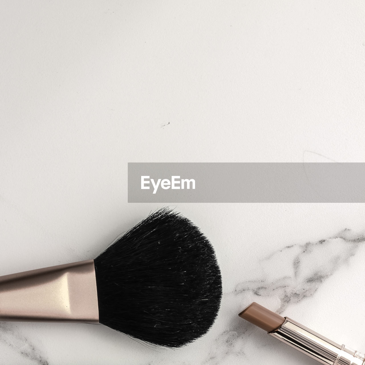 high angle view of make-up brushes against white background