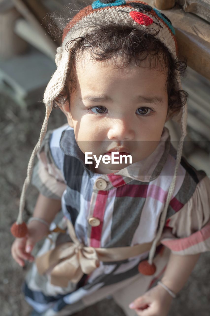 Portrait of cute baby girl looking away