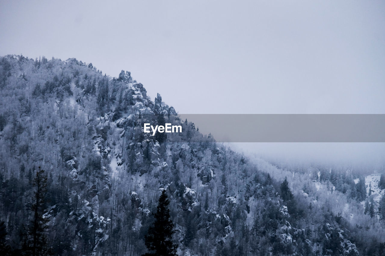 Scenic view of snow covered mountains against sky